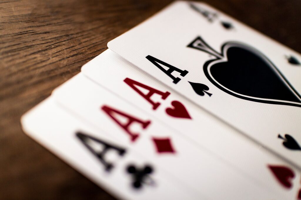 Four aces on a wooden table