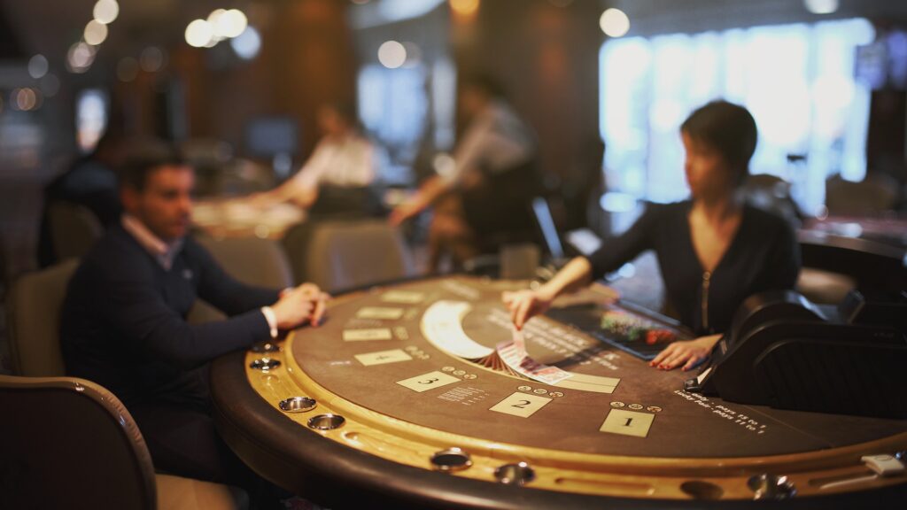 A blackjack dealer at a blackjack table