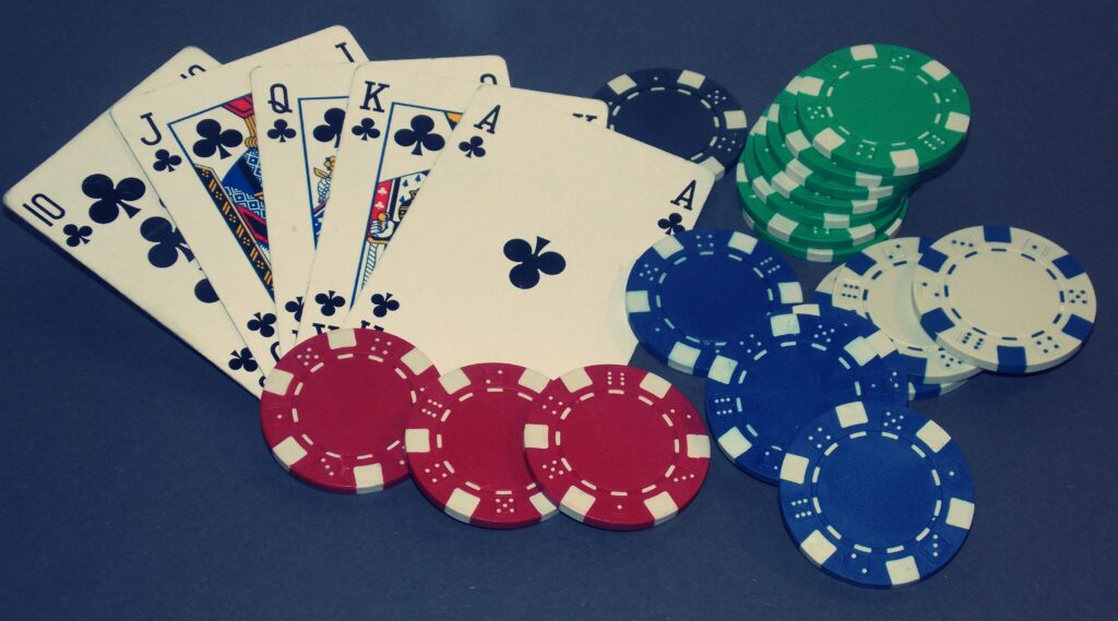 A royal flush with poker chips around it