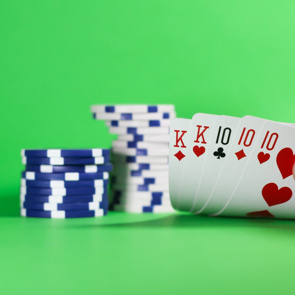 A full house in front of poker chips