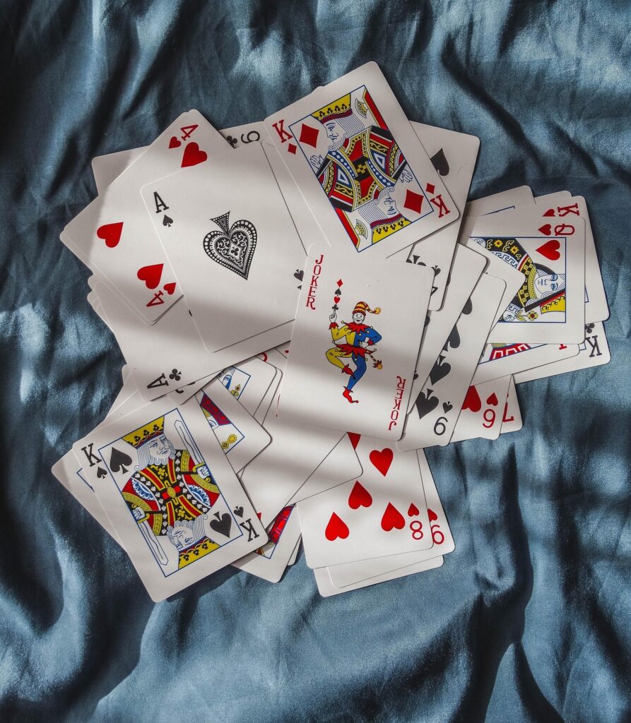 Playing cards spread on a light blue fabric