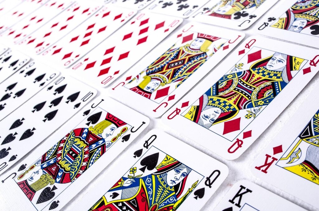 A deck of cards placed in order on a white surface