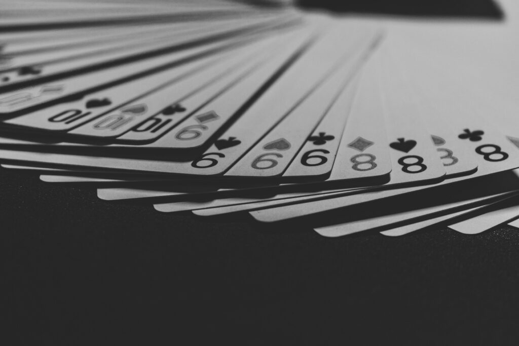 Playing cards spread out on a black surface