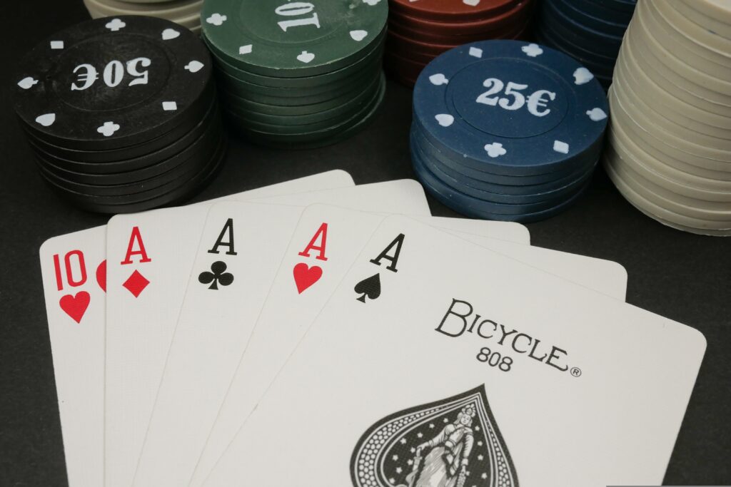 Four aces in front of poker chips