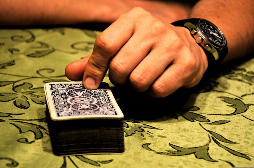 Somebody picking up a card off the top of the deck