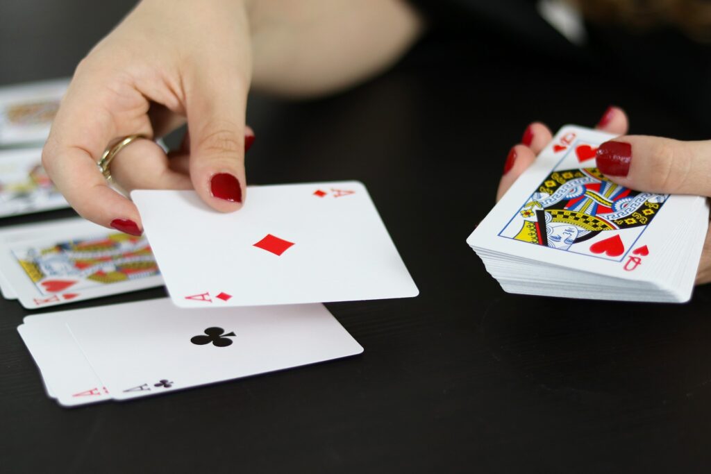 Somebody dealing cards into piles