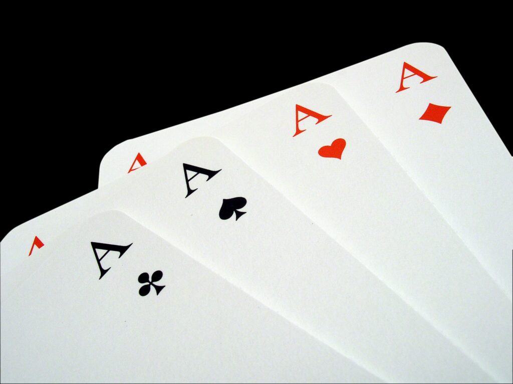 Four aces on a black surface